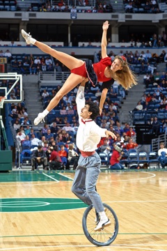 Teresa and Sem Abrahams performing their Semcycle unicycle act in a packed arena